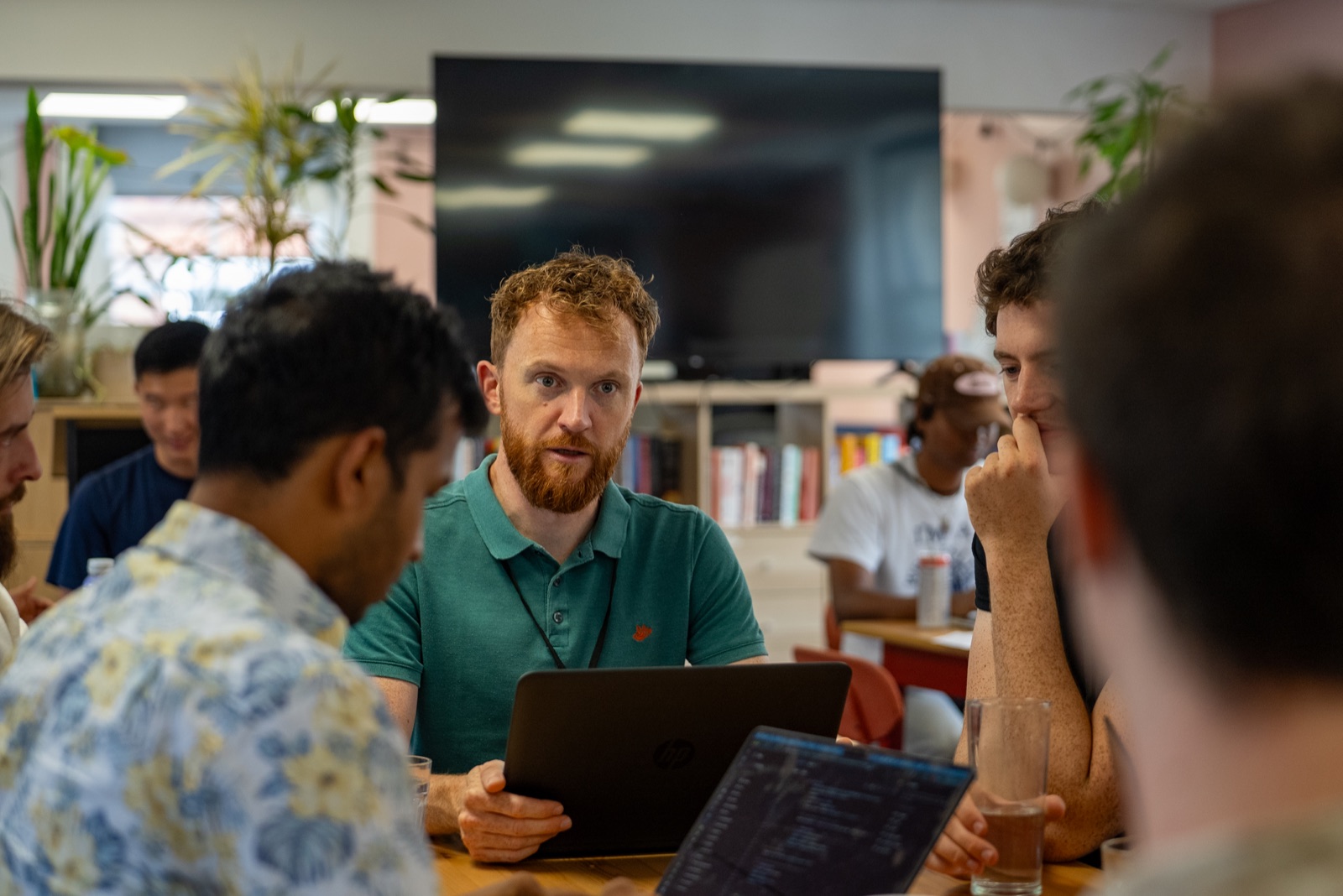 Participants working together around a laptop