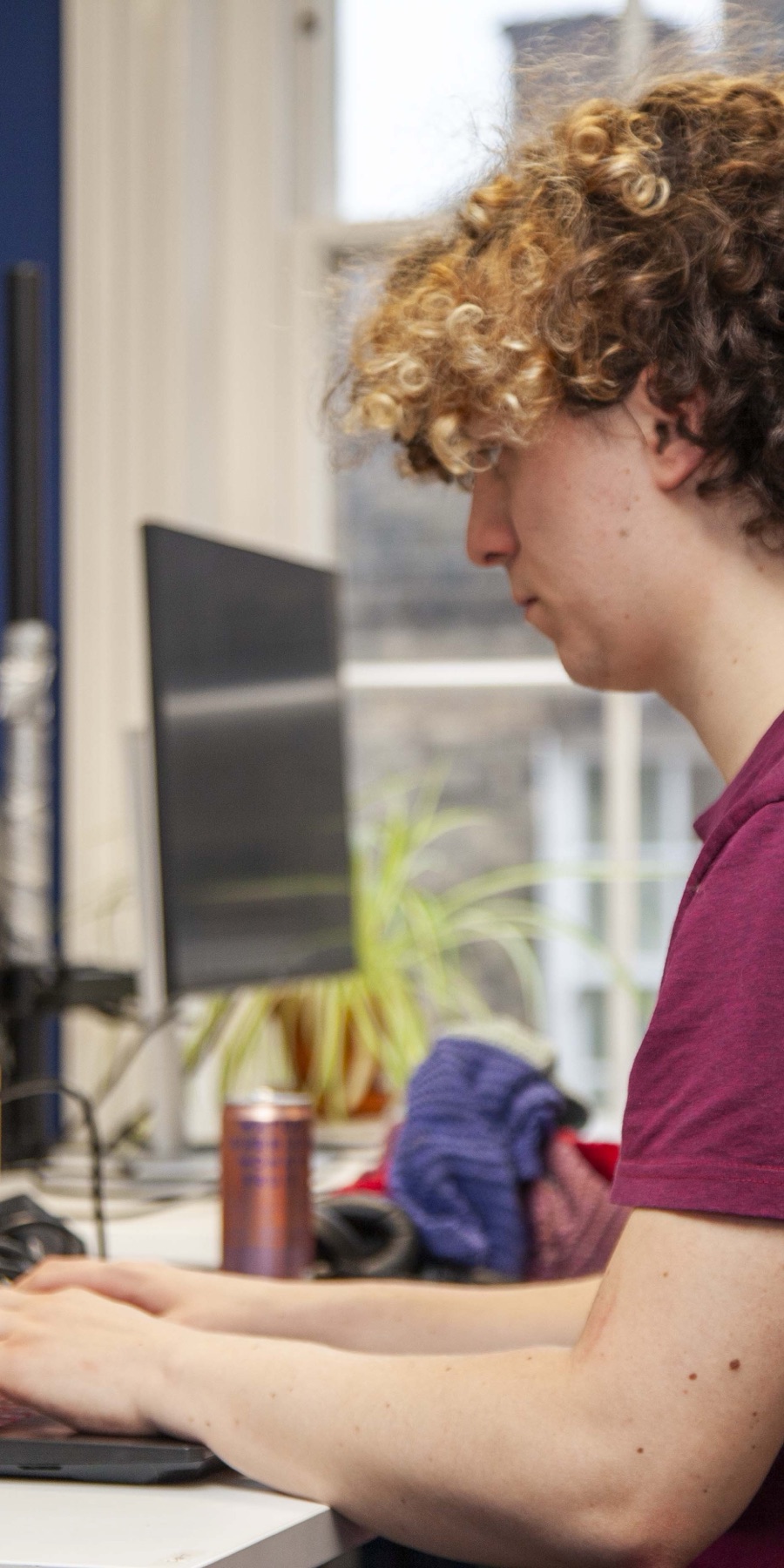 A team member working at a desk in the Meridian office
